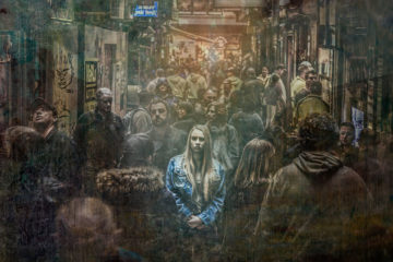 Woman alone in a crowd maintaining situational awareness